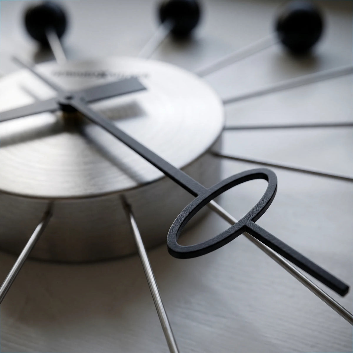 Howard Miller Ball Clock II Wall Clock, macro close-up of the hands and dial