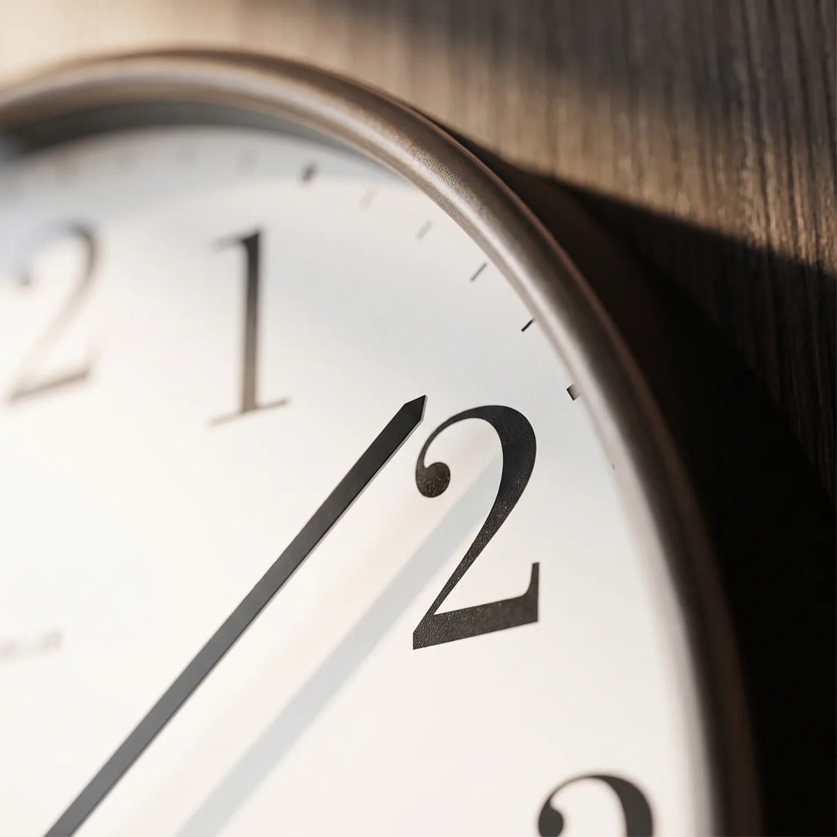 Howard Miller Office Mate Wall Clock, macro close-up of the hands and dial