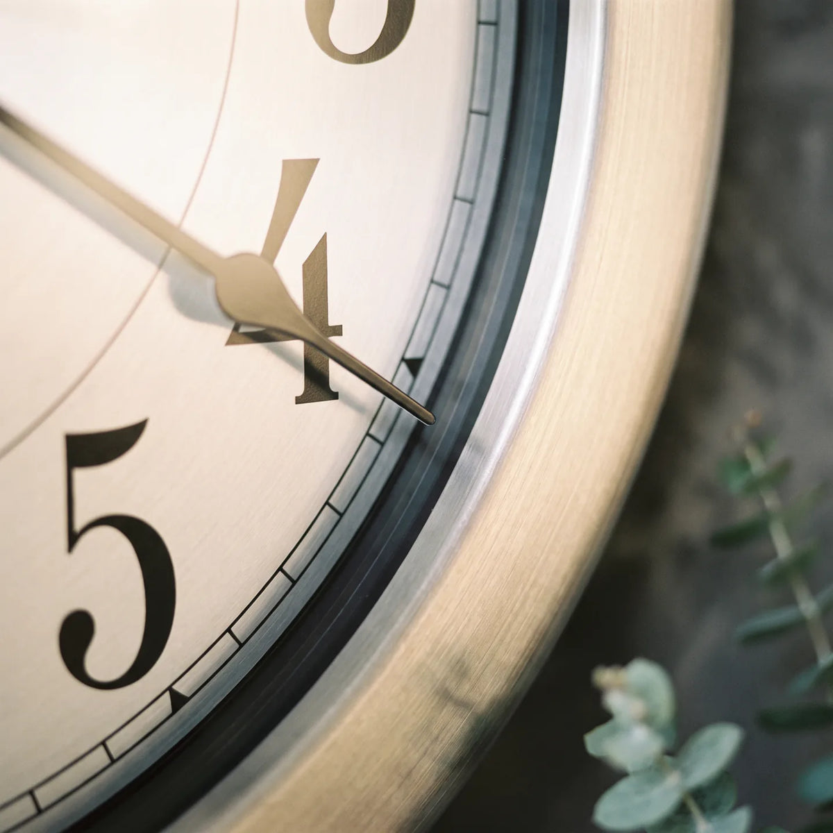 Howard Miller Pisces Wall Clock, macro close-up of the hands and dial