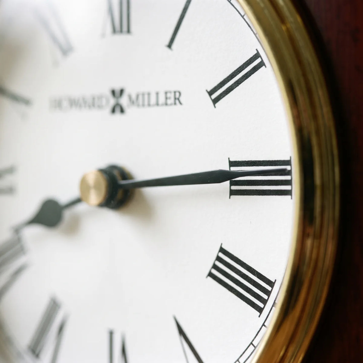 Howard Miller Rosewood Encore Bracket Tabletop Clock, macro close-up of the hands and dial