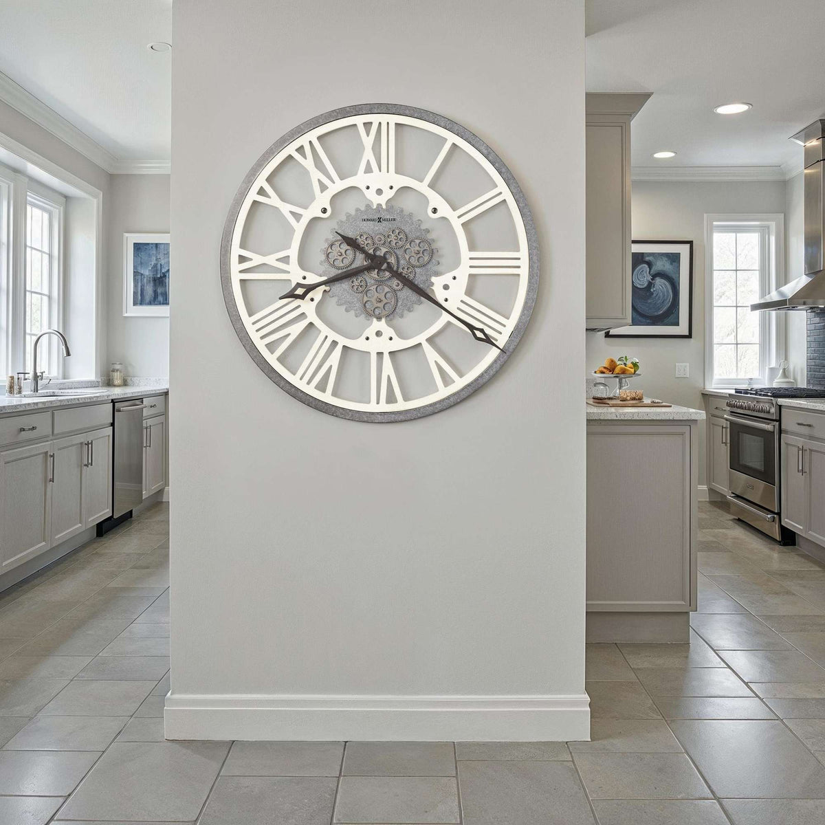 A modern wall clock with a decorative design displayed in a contemporary kitchen setting.