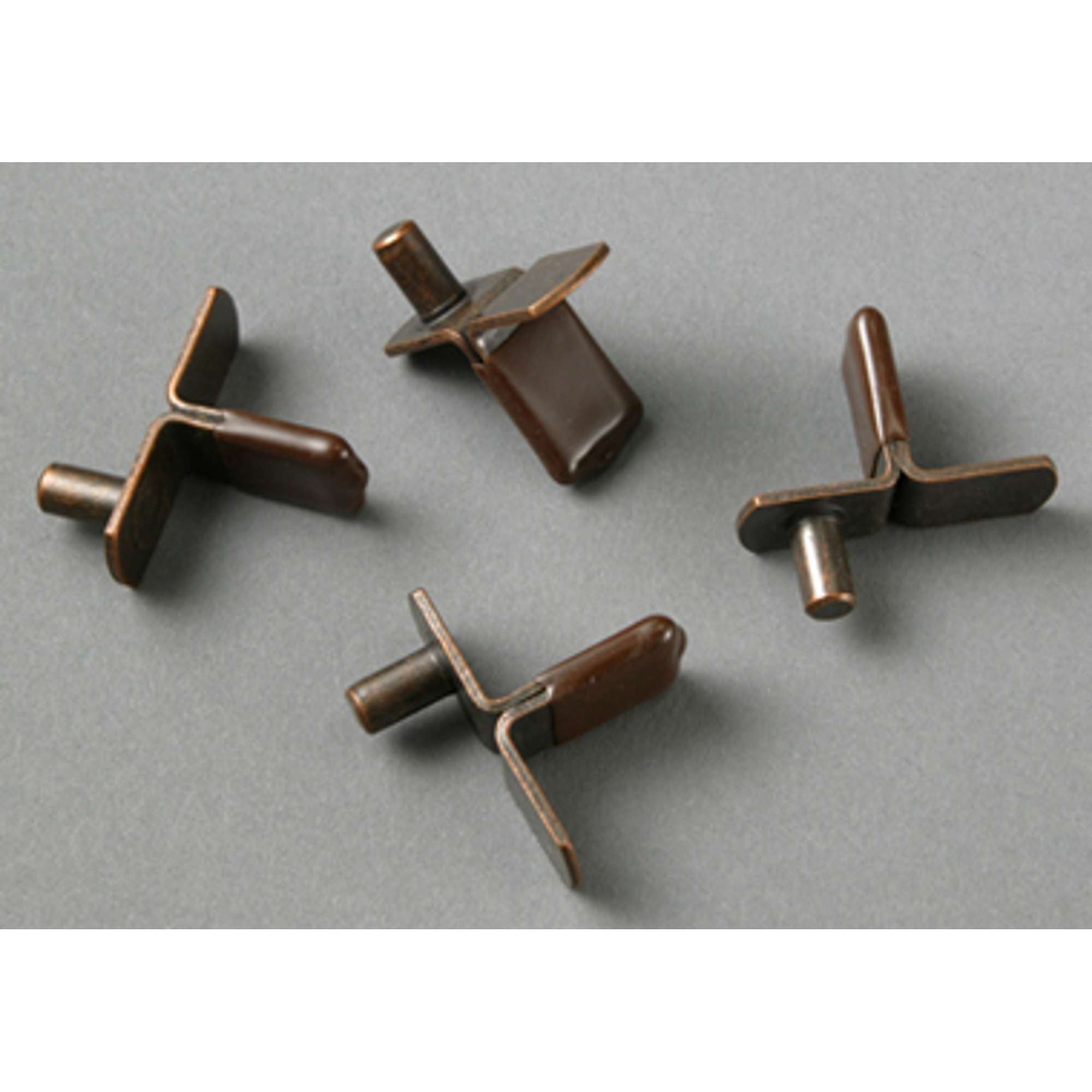 Four brown metal clips arranged on a gray background.
