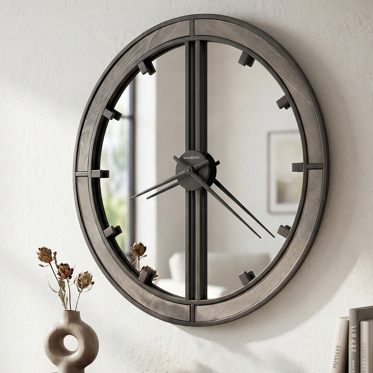 Round wall clock with wooden frame on a white wall