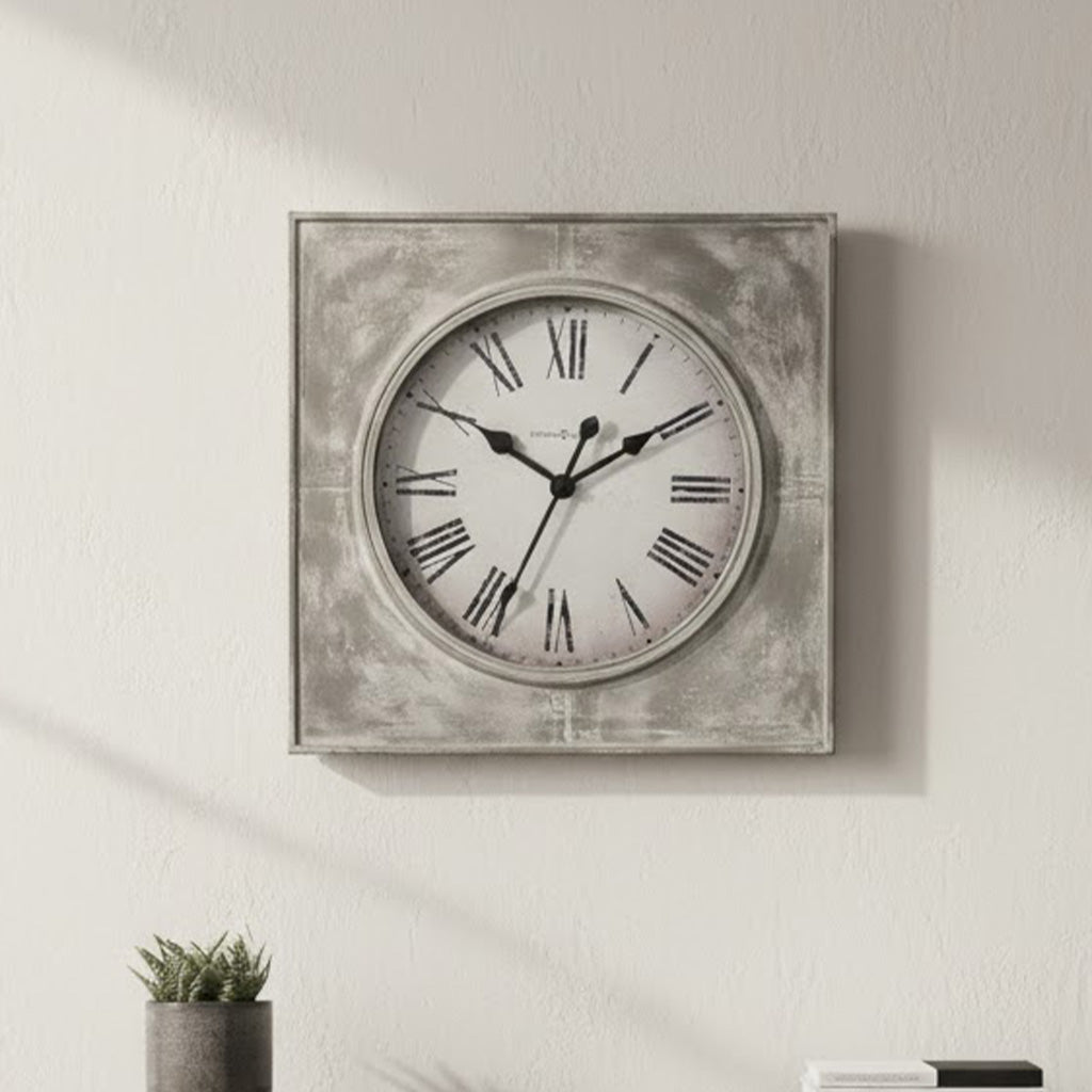 Vintage-style wall clock with a distressed gray frame, Roman numerals, and sleek black hands.