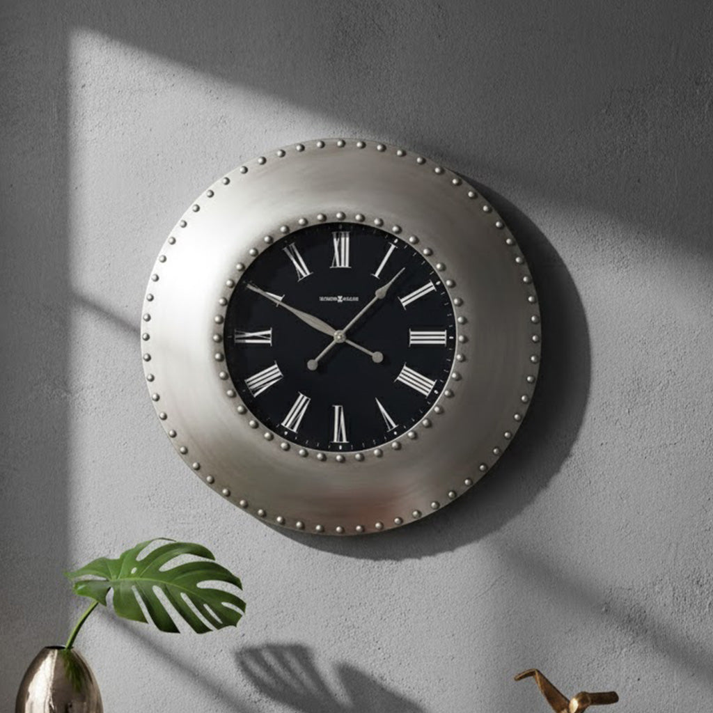 Stylish round wall clock with silver finish, black face, white Roman numerals, and studded design.
