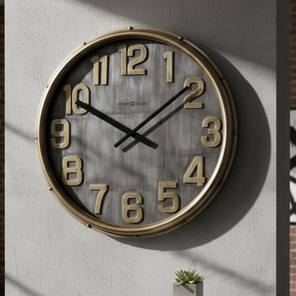 Large round wall clock with gold numbers, grey wood background, and black clock hands.