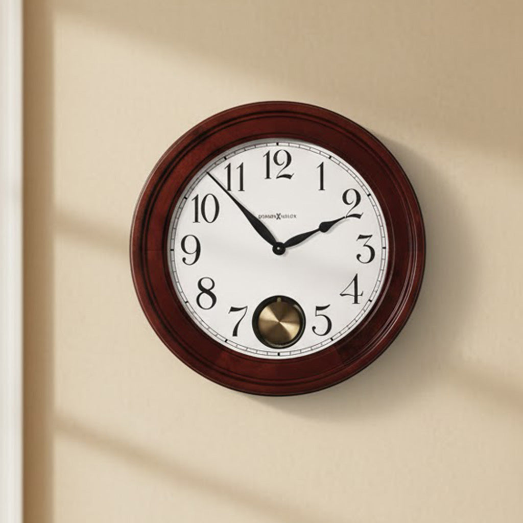 Wooden wall clock with classic design, white face, black numbers, and brass pendulum detail.