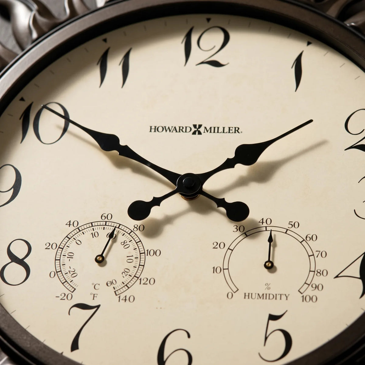 Howard Miller Sunburst II Indoor/Outdoor Wall Clock, close-up of the dial and finish detail