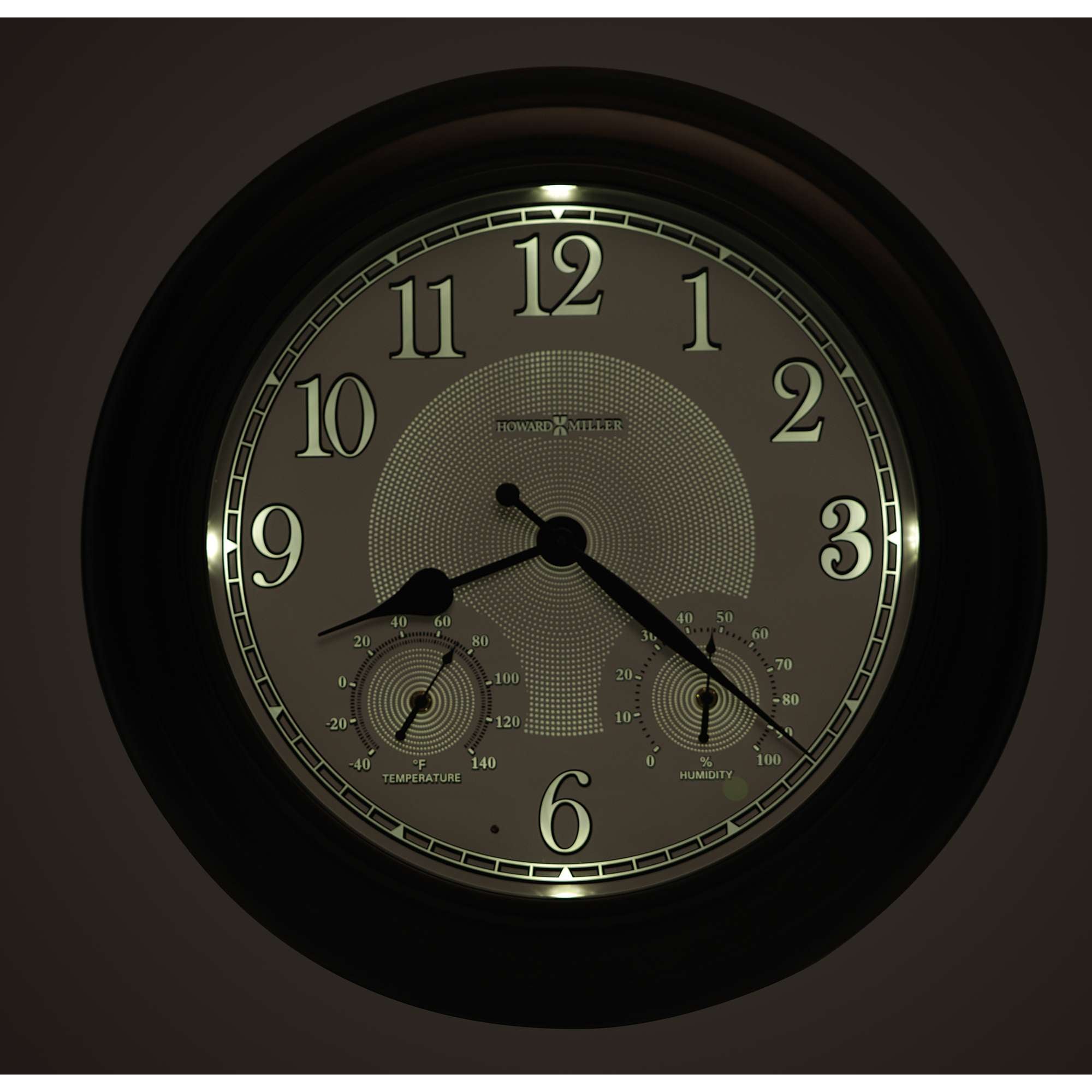 A wall clock with visible hour, minute, and second hands, featuring two additional dials for measuring temperature and humidity.