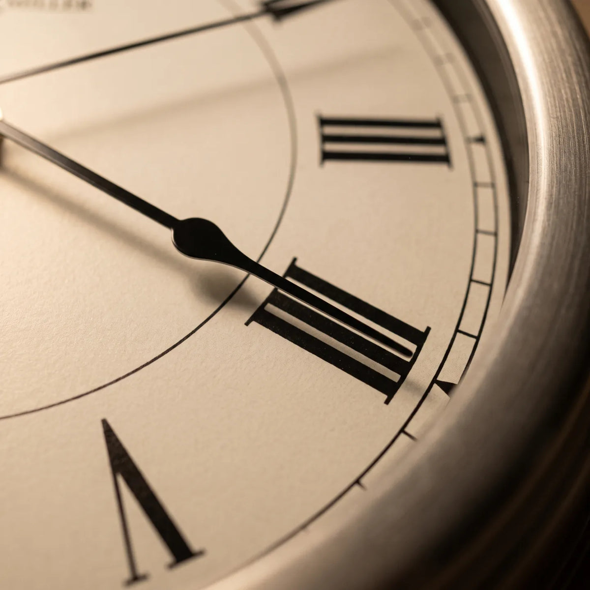 Howard Miller Aries Wall Clock, macro close-up of the hands and dial