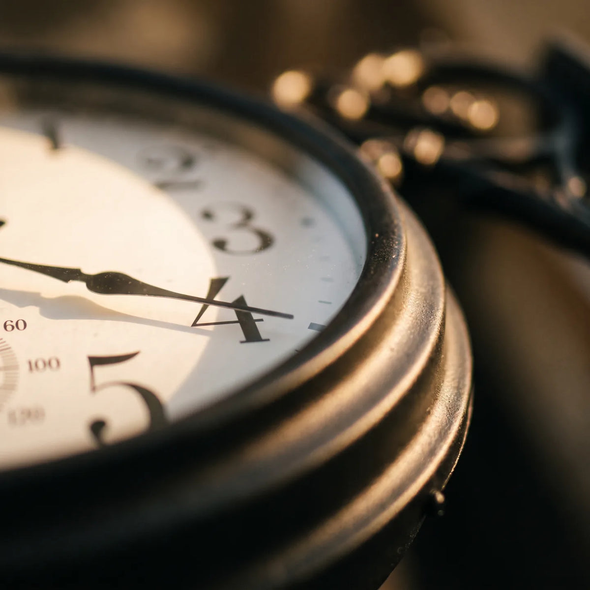 Howard Miller Luis Indoor-Outdoor Wall Clock, macro close-up of the hands and dial