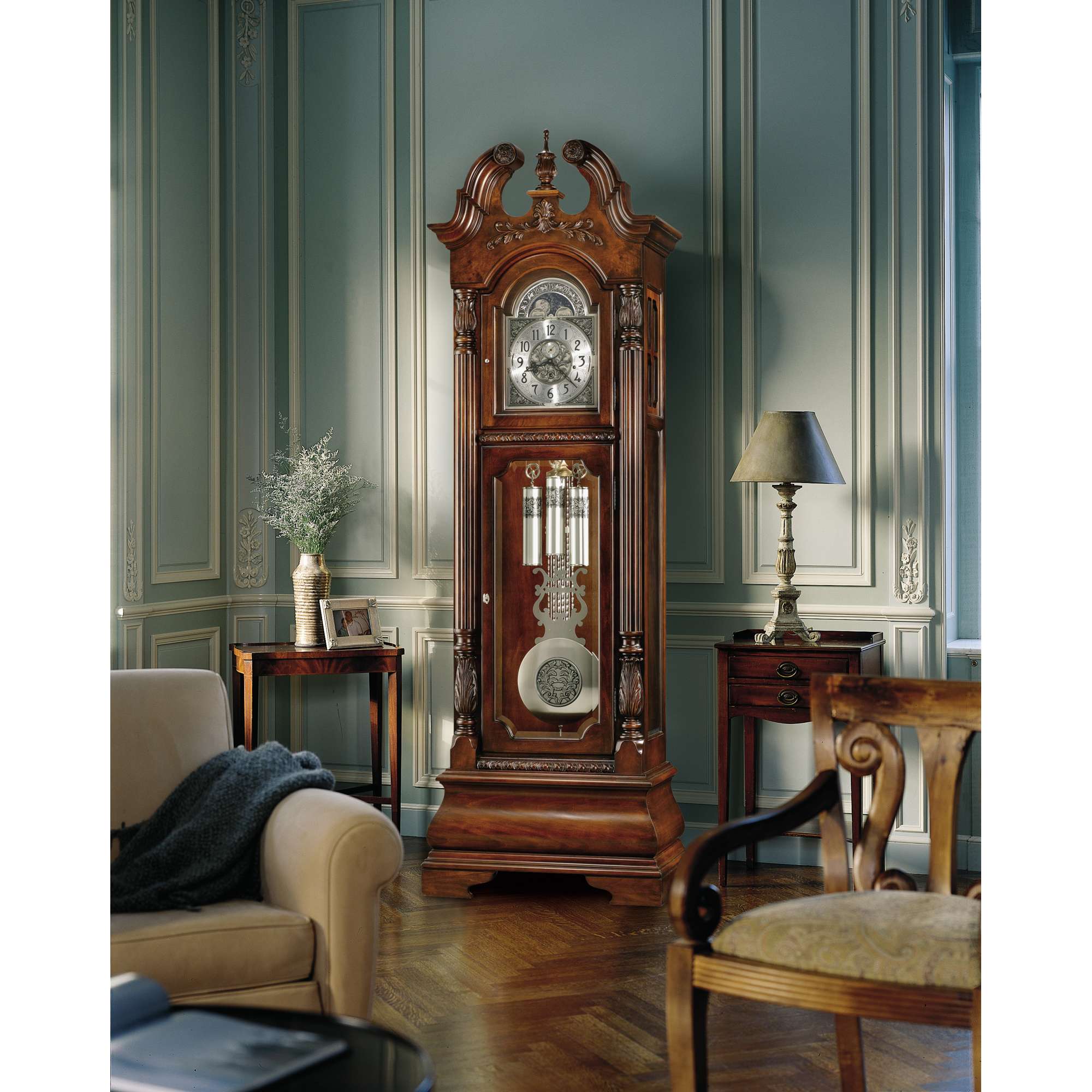 A vintage grandfather clock placed in a stylishly decorated room with elegant furnishings.