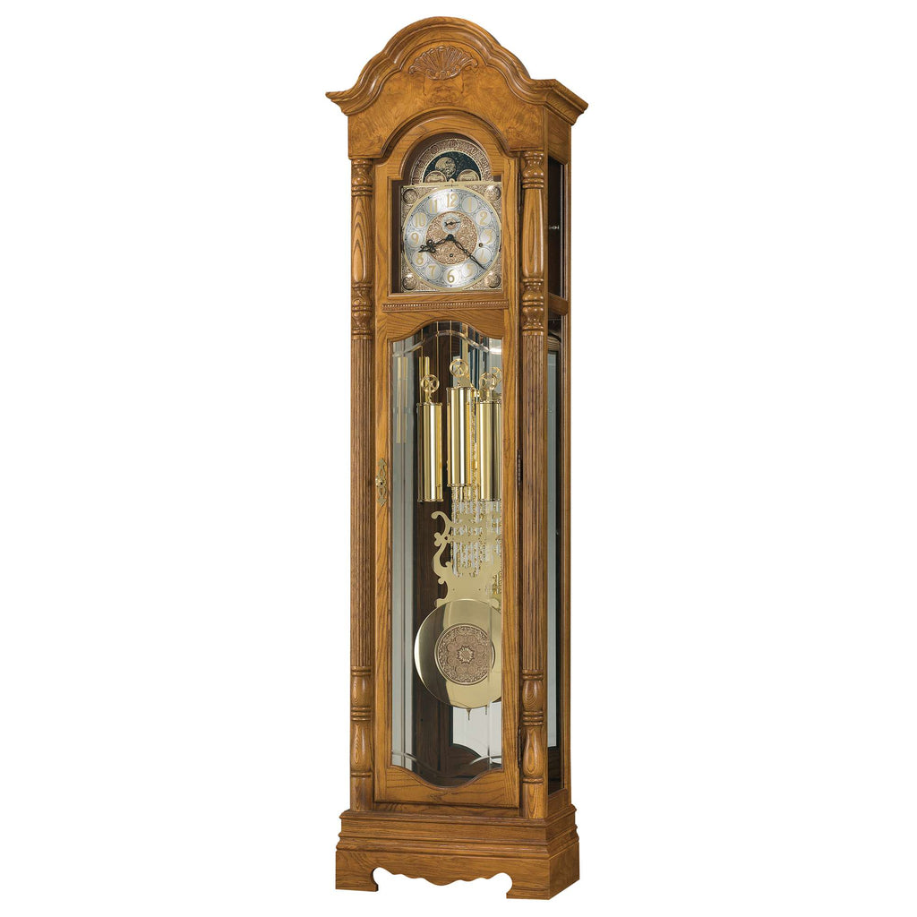 Tall wooden grandfather clock with pendulum and decorative face.