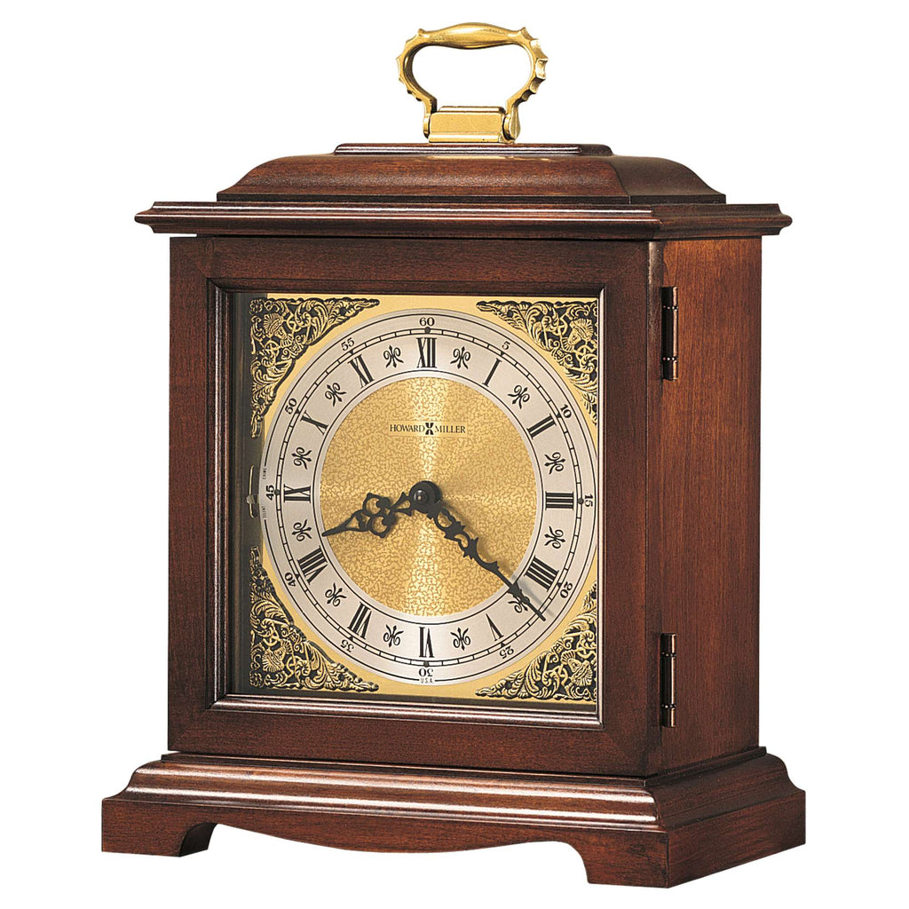 A vintage wooden mantel clock with ornate detailing and a golden clock face.