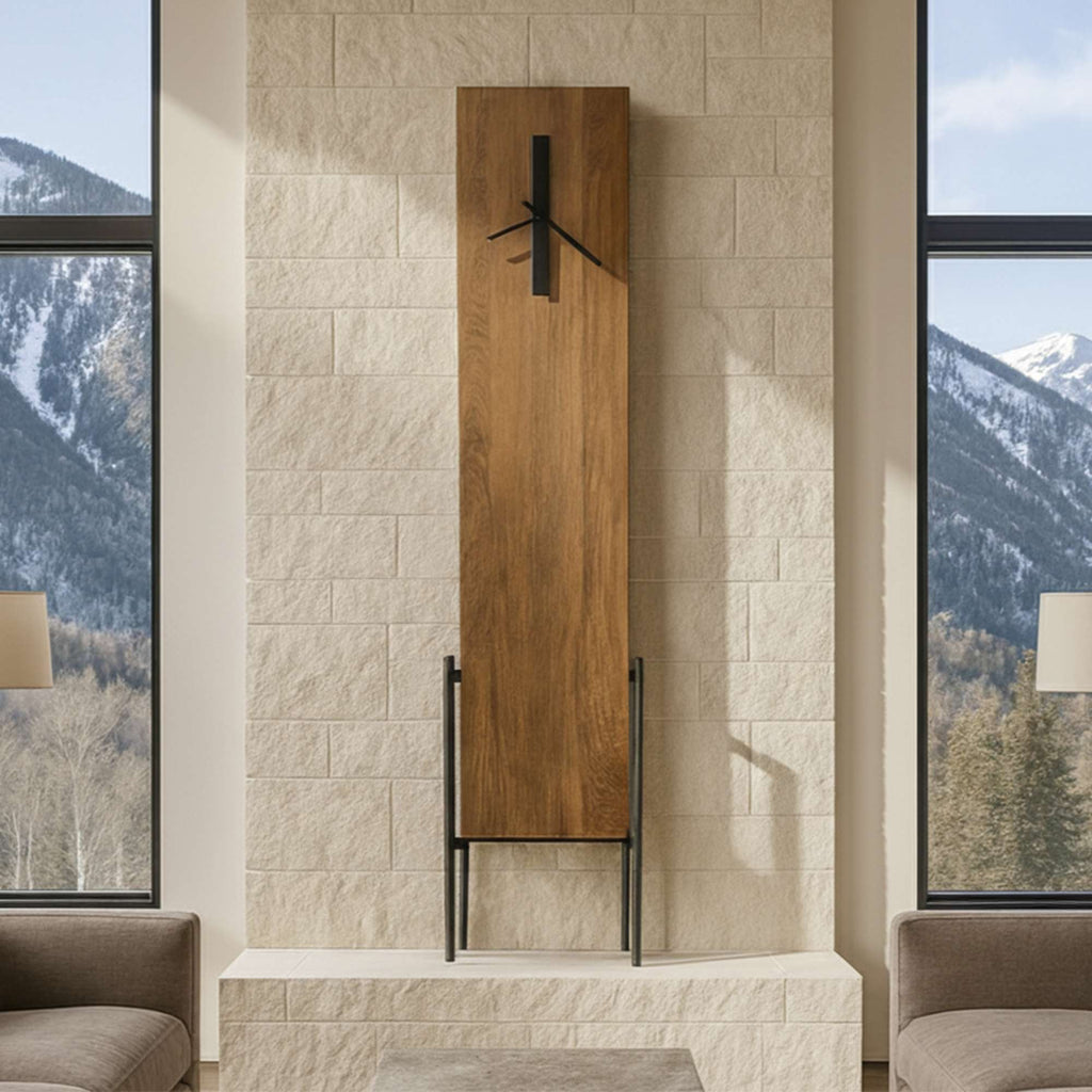 Modern wooden wall clock on a stone feature wall, with mountains visible through large windows.