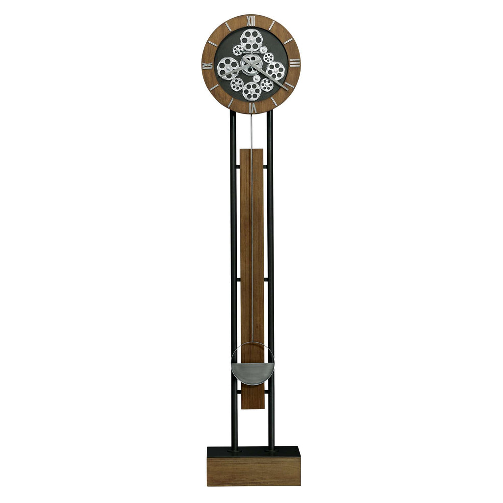 A tall, modern wall clock with a circular face and decorative gear design.