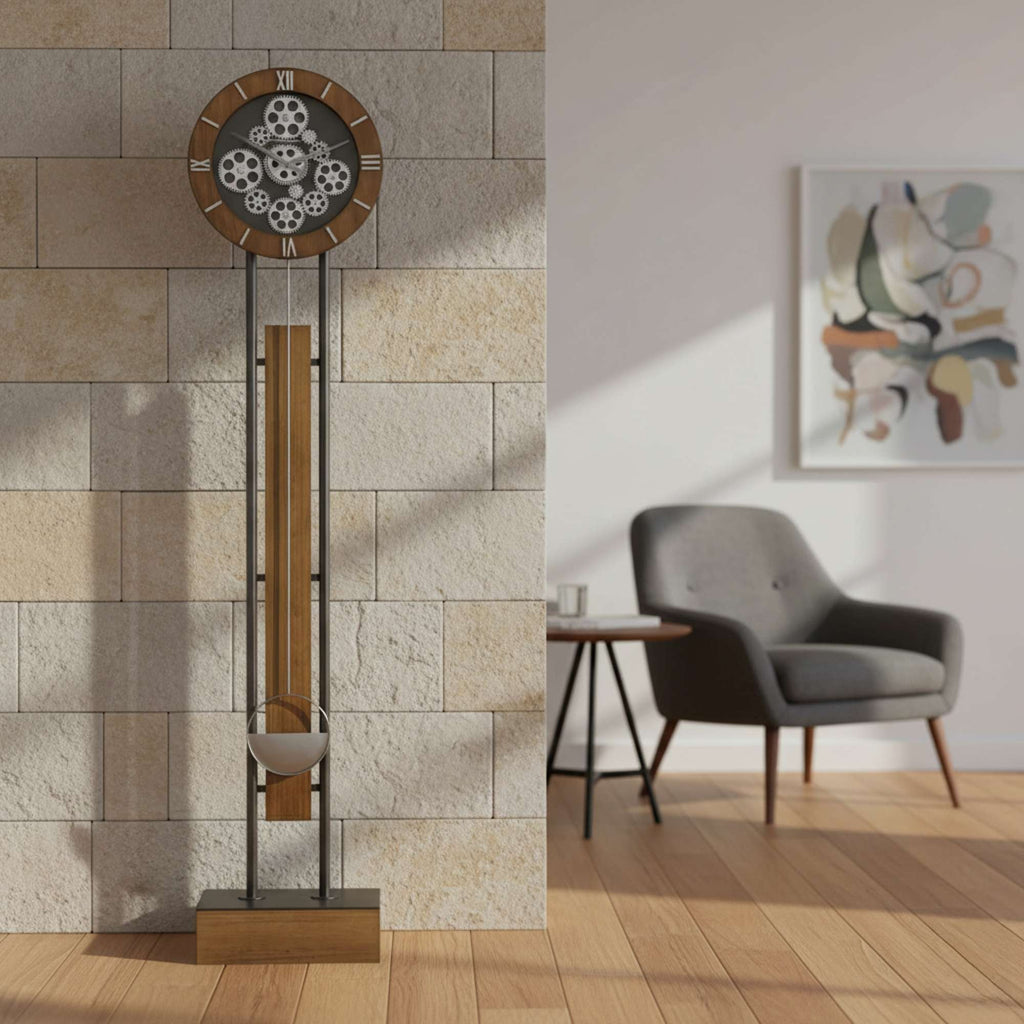 A modern wall clock against a stone wall, next to a stylish chair and an abstract artwork.