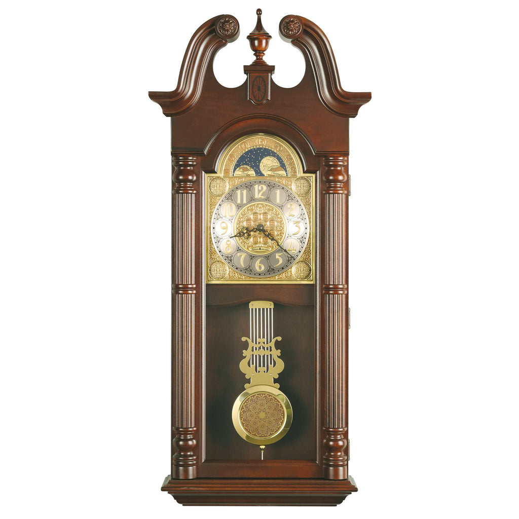 A decorative wooden wall clock with a gold and silver face and pendulum.