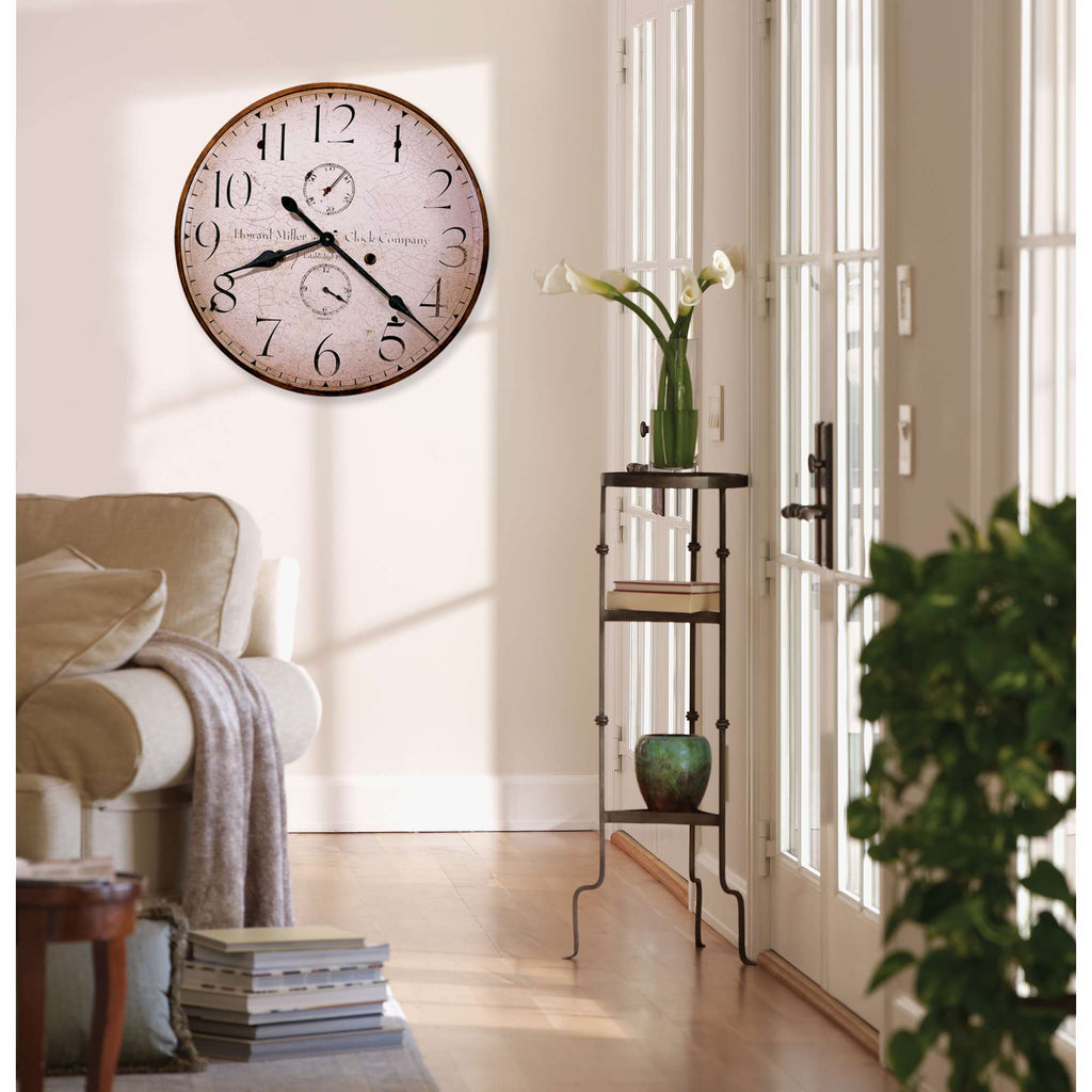 Cozy living room with a large wall clock and potted plant on a small table