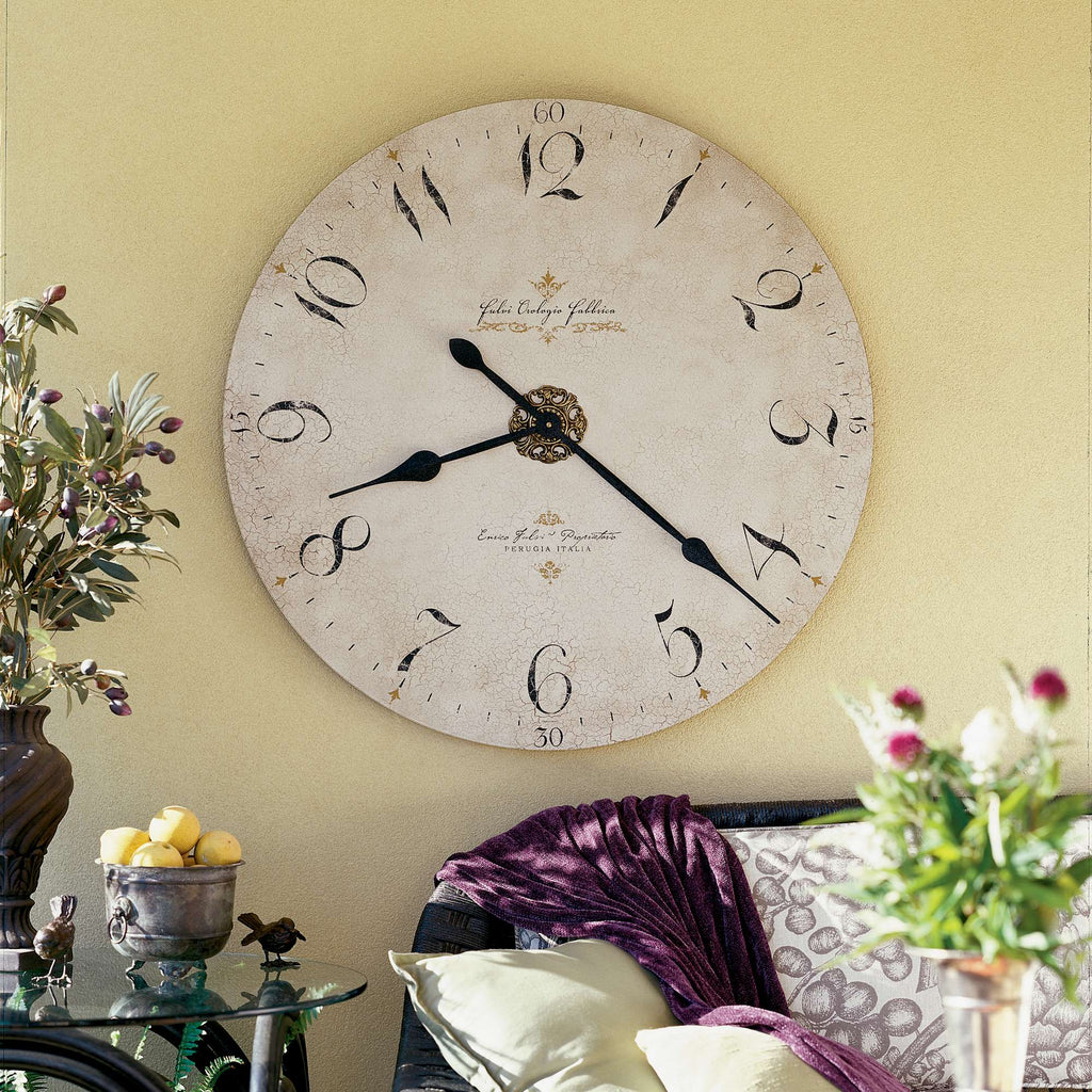 Wall clock with Roman numerals and decorative elements in a cozy living room setting.