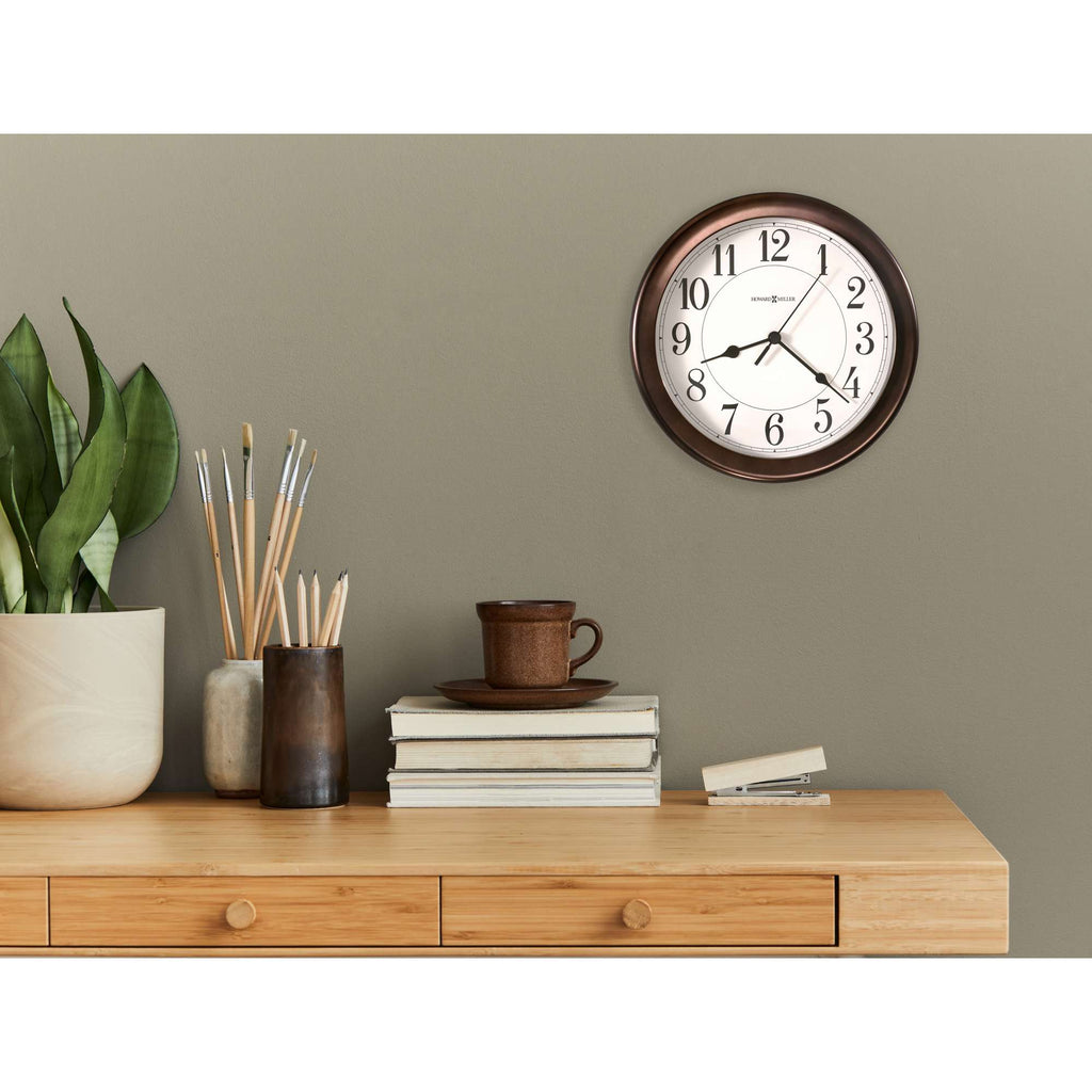 A serene interior scene featuring a wooden table with books, a cup, decorative objects, and a wall clock above it.