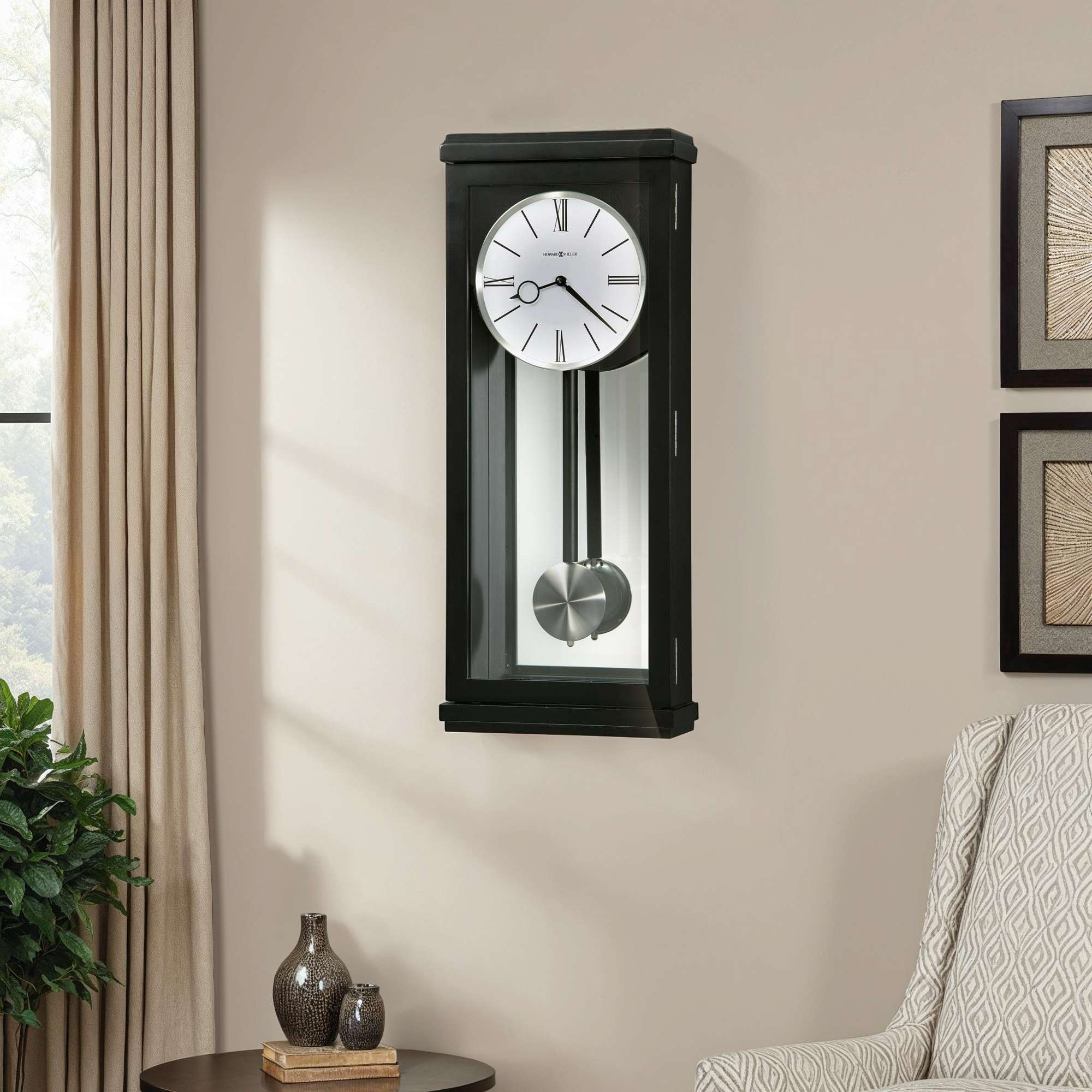 A wall-mounted clock with a pendulum, set against a neutral wall.