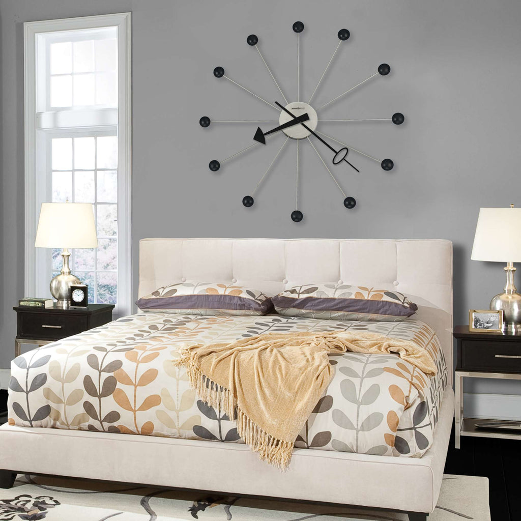 Cozy bedroom featuring a stylish bed and a large wall clock
