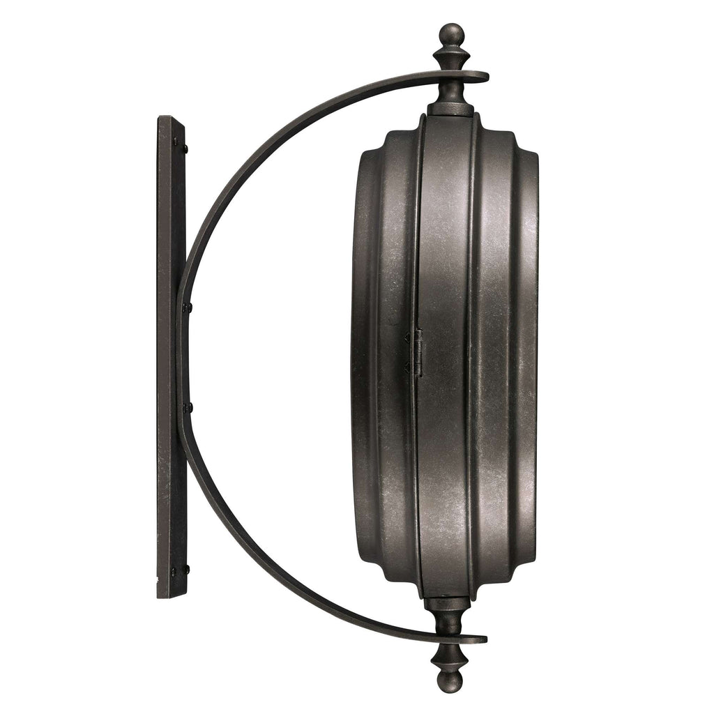 A round, wall-mounted mirror with a dark metal frame and decorative detailing.