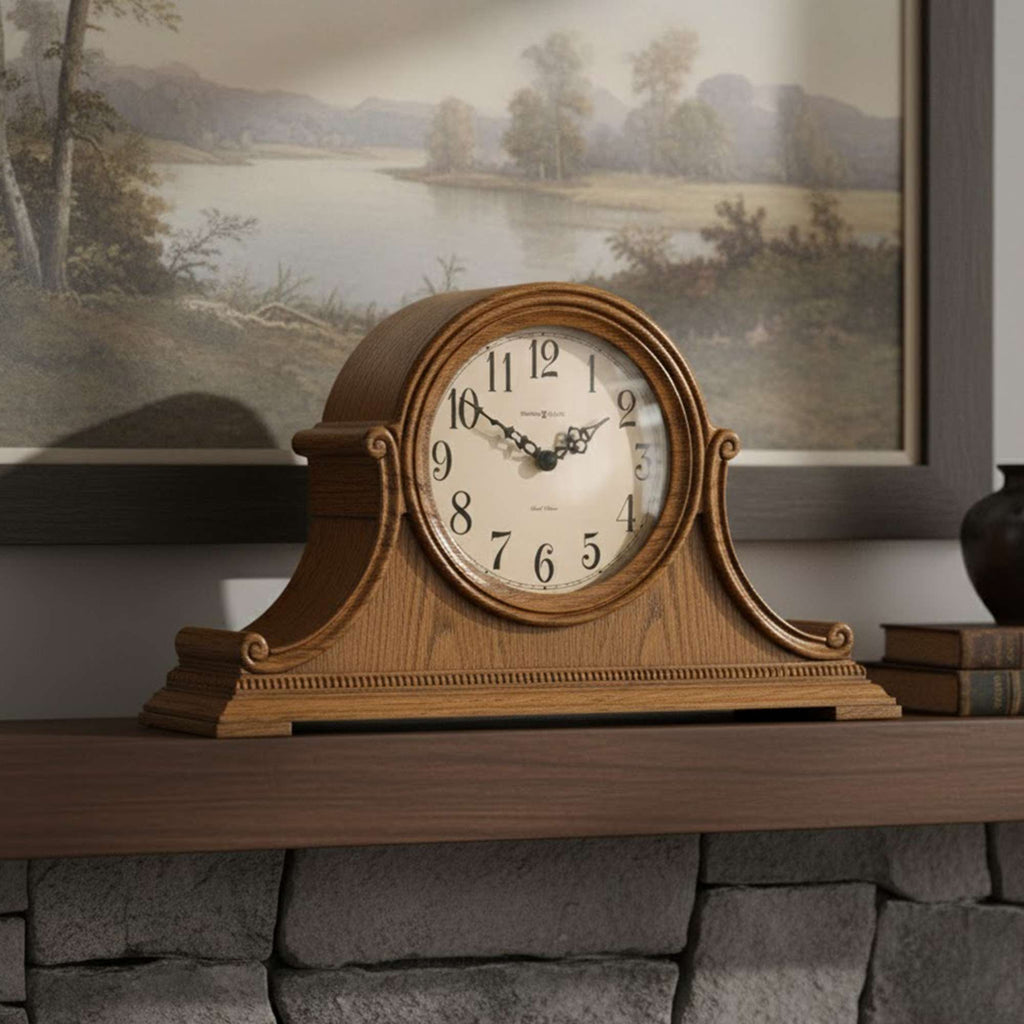 A wooden mantel clock displayed on a stone shelf with a scenic painting in the background.