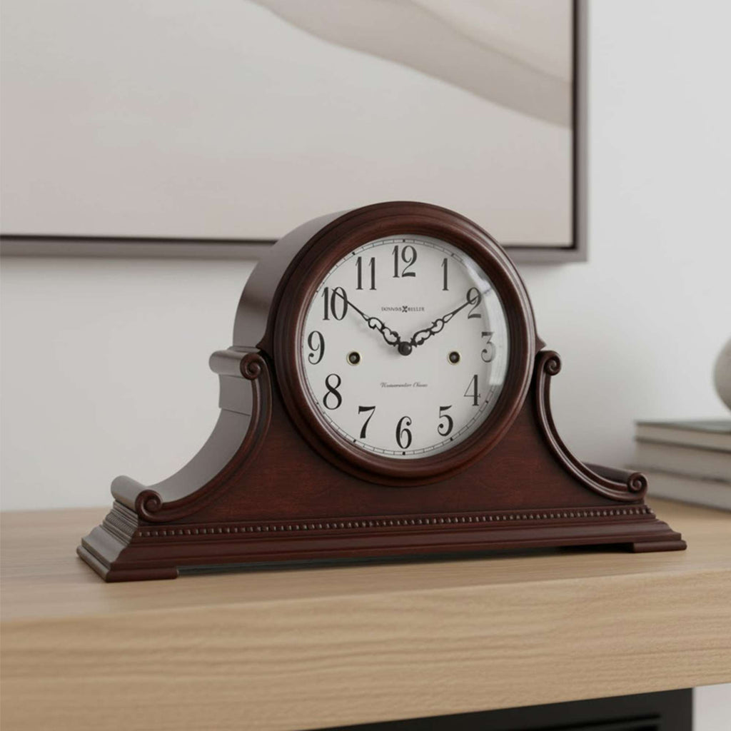 A vintage-style wooden mantel clock on a wooden surface.