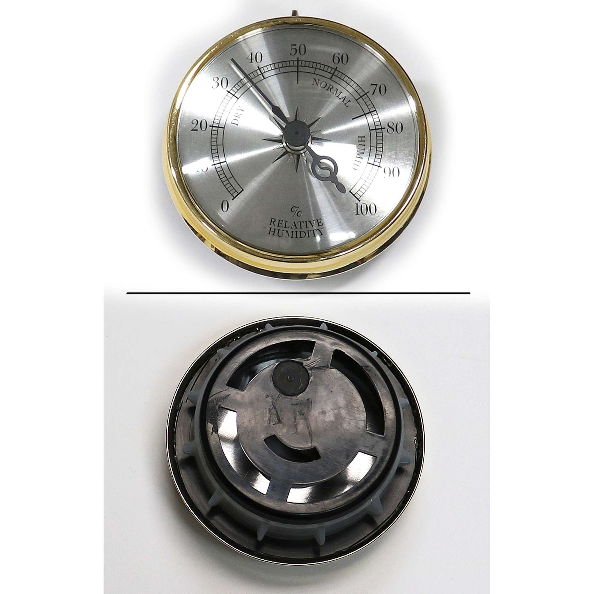 Top view of a silver and gold dial thermometer, with a black plastic backing visible in the bottom half.