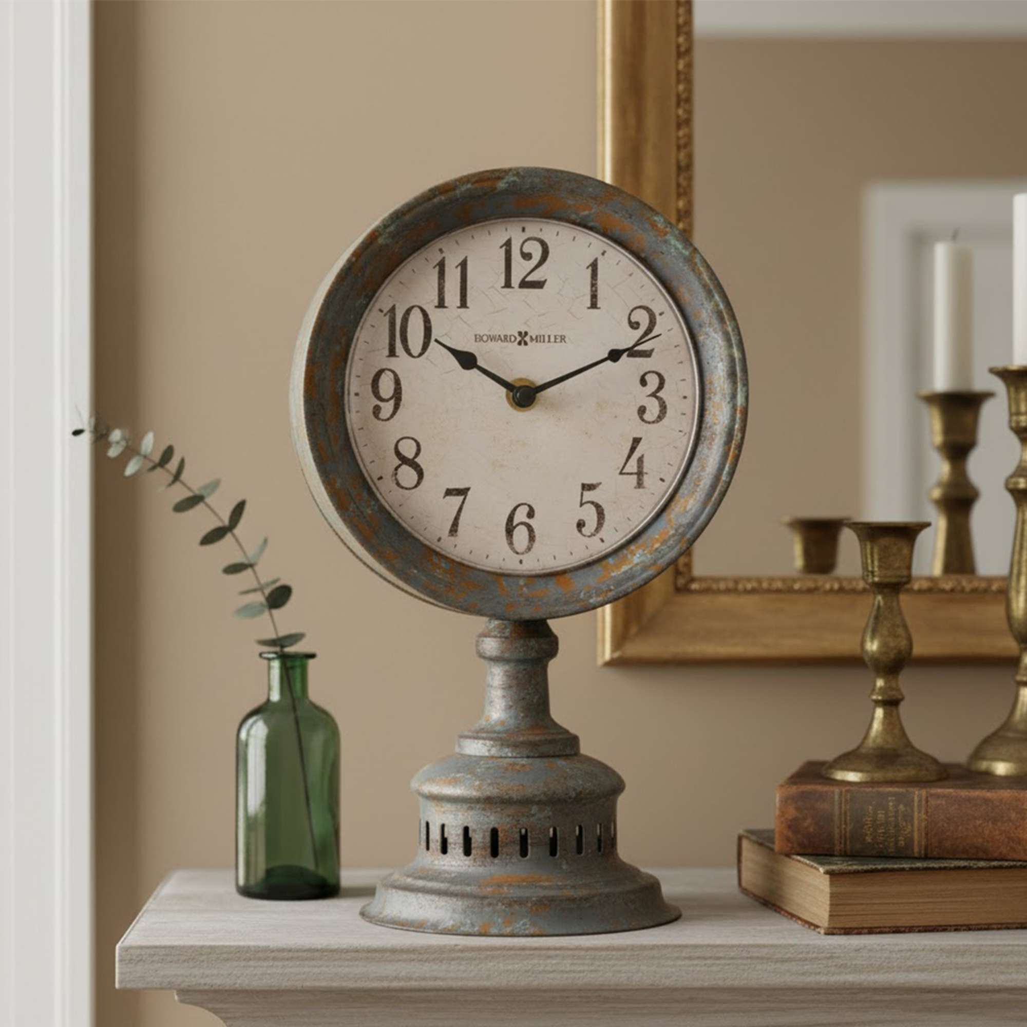 Vintage-style clock on a mantel with a glass bottle and candlesticks in the background.