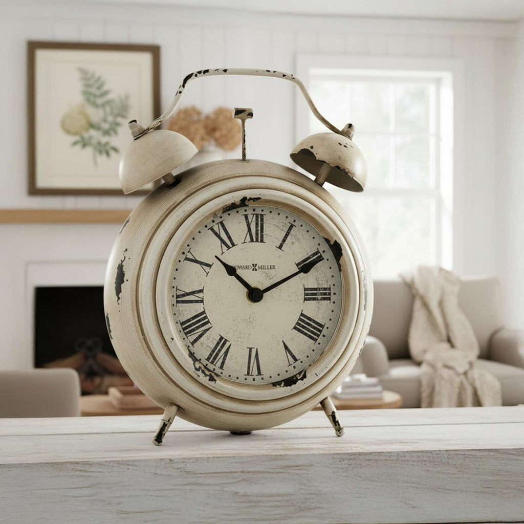 Vintage alarm clock with Roman numerals placed on a wooden table in a cozy living room setting.