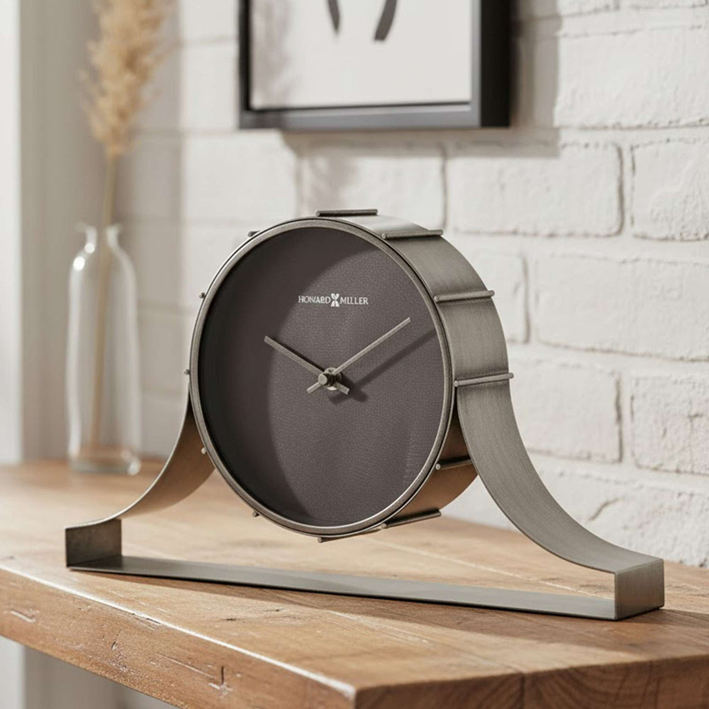 Modern clock on a wooden table with a minimalist design.
