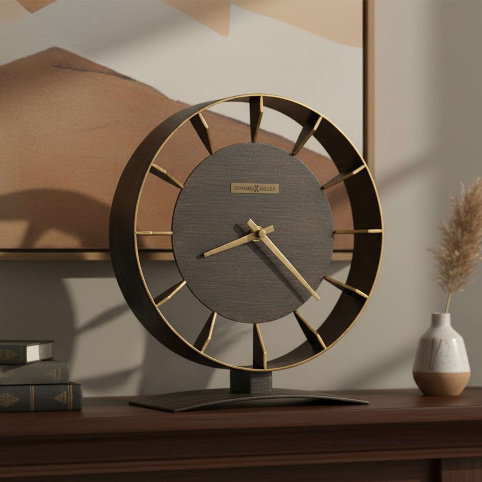 A stylish modern clock with a circular design, displaying a mix of wood and gold accents, placed on a wooden table.