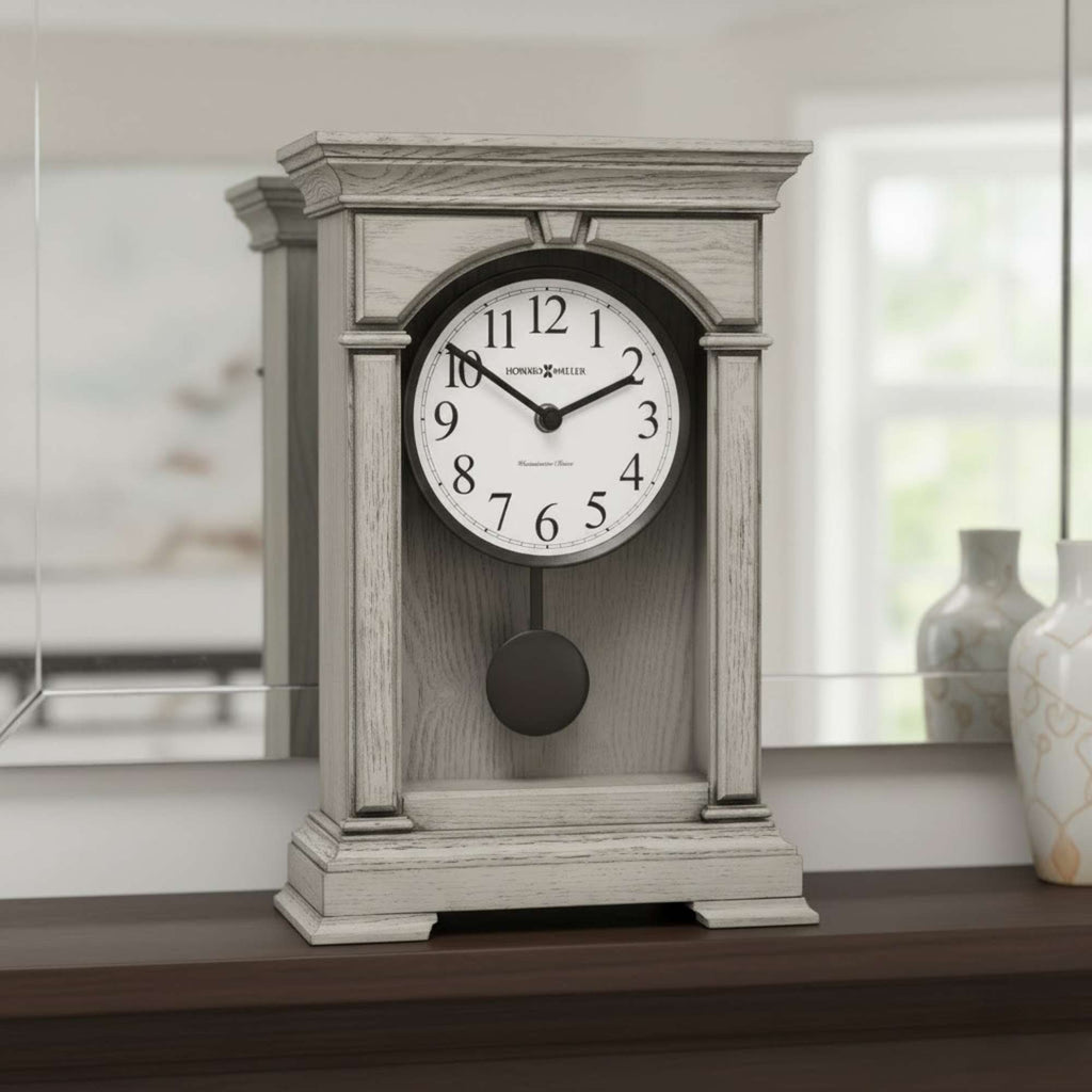 A classic wall clock with a white face and pendulum, set on a wooden shelf.