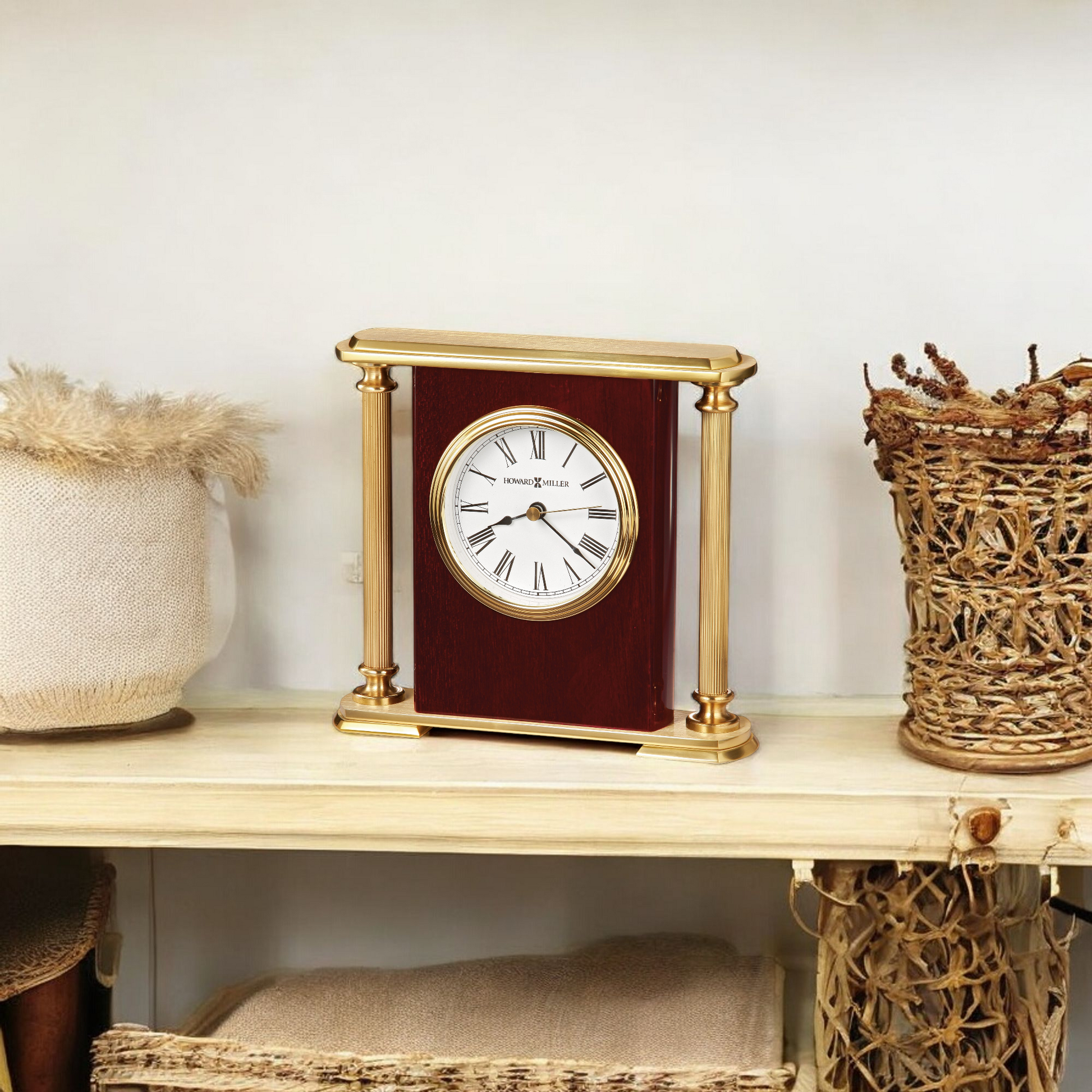 A decorative mantel clock on a wooden shelf next to woven baskets.