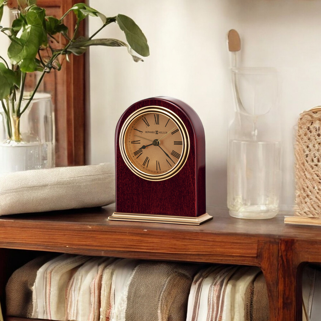 A decorative vintage clock on a wooden shelf with cozy decor.