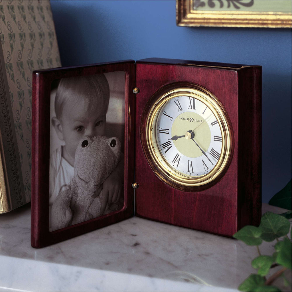 A wooden clock with a photo frame, displaying a black and white image of a child holding a stuffed animal.