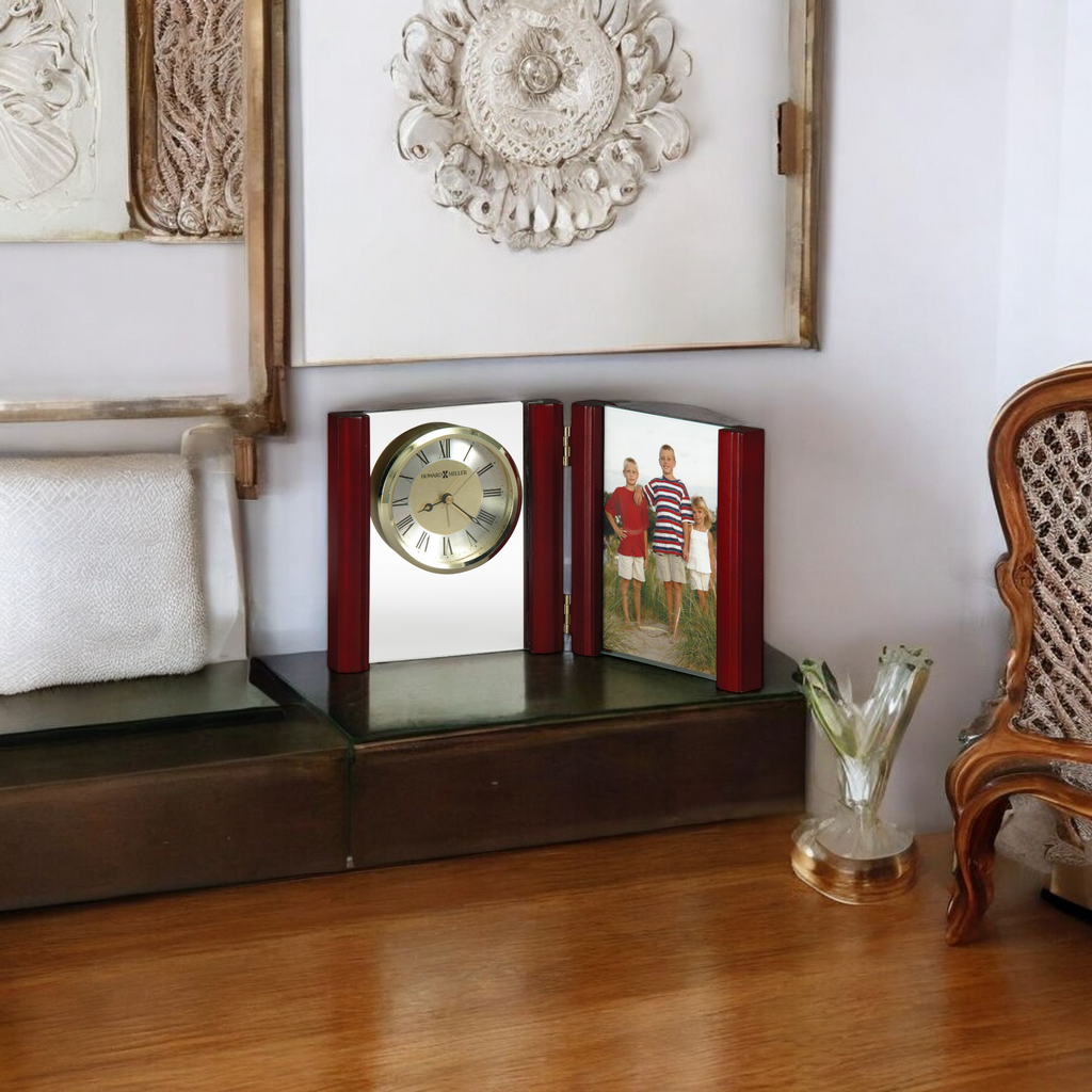 A decorative wooden shelf featuring a clock and a photo frame with a family picture.