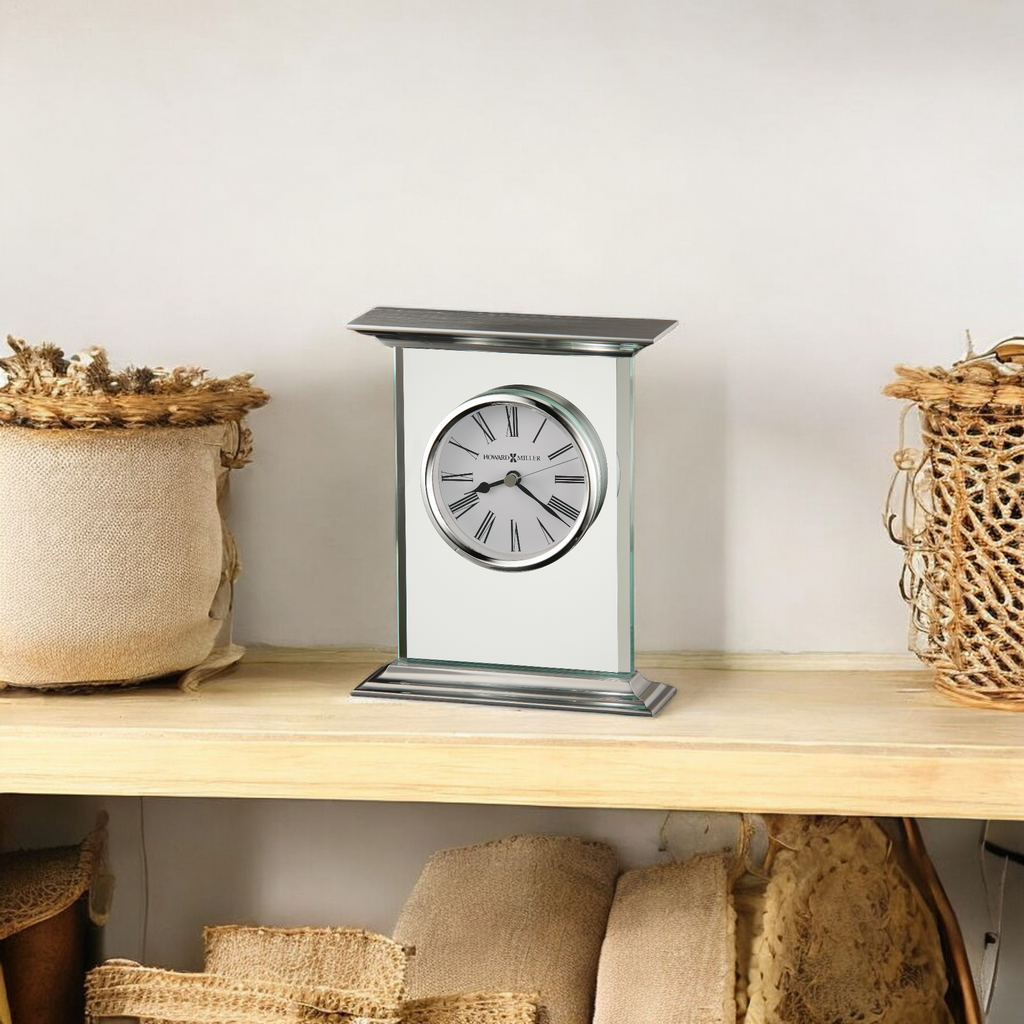 A stylish clock displayed on a wooden shelf with decorative storage baskets.