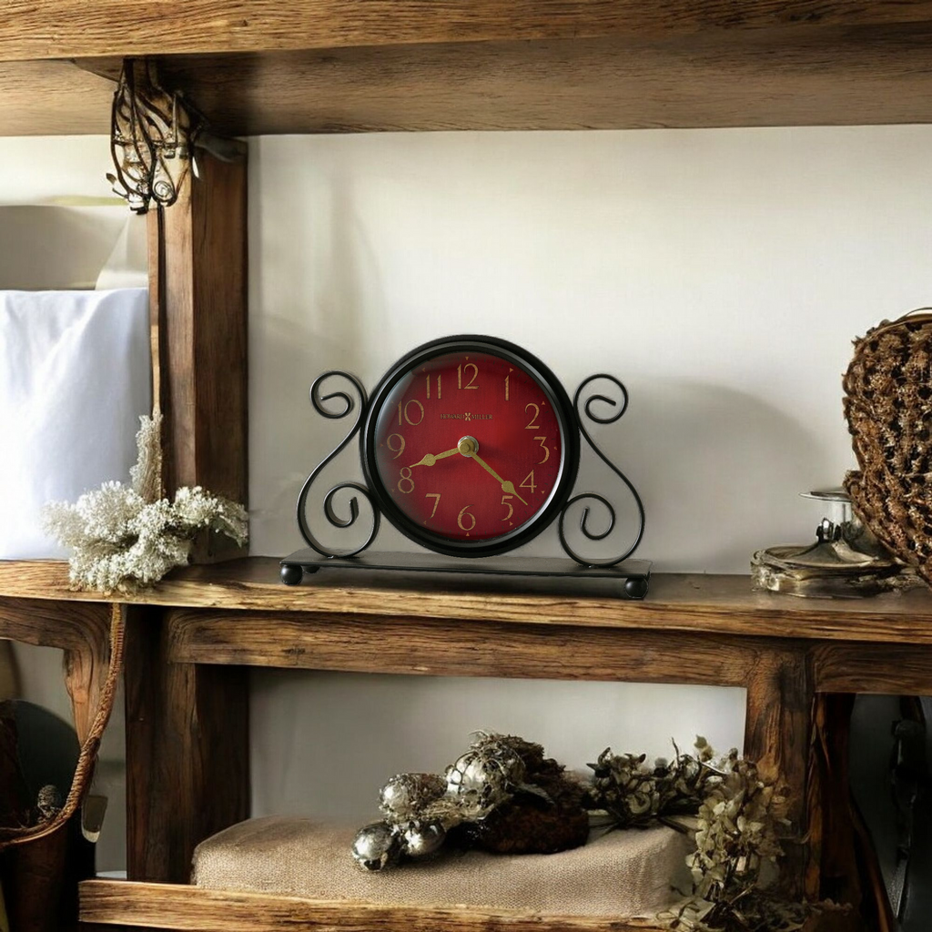 Vintage red clock on a wooden shelf with decorative items