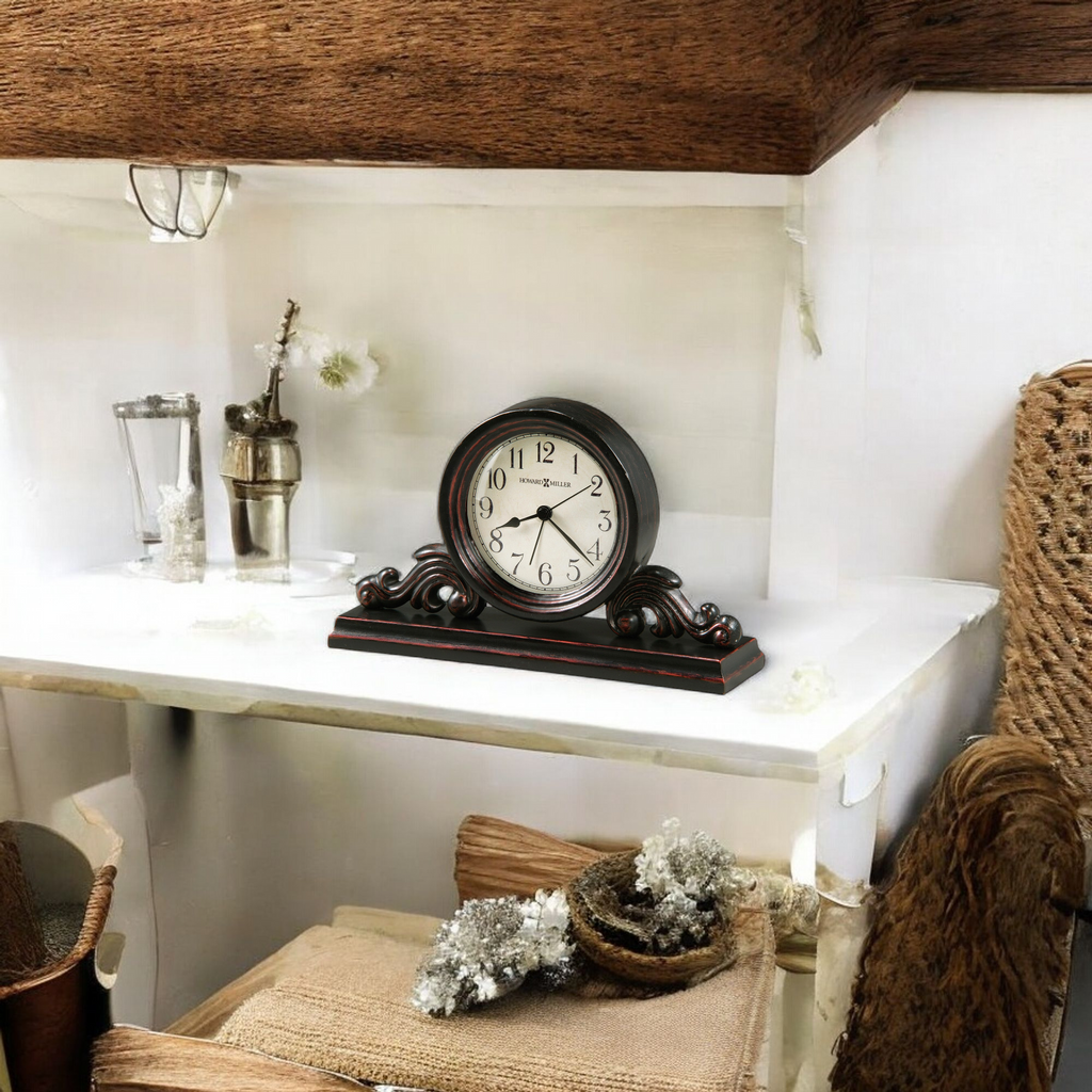 A vintage clock displayed on a white shelf with decorative items around it.