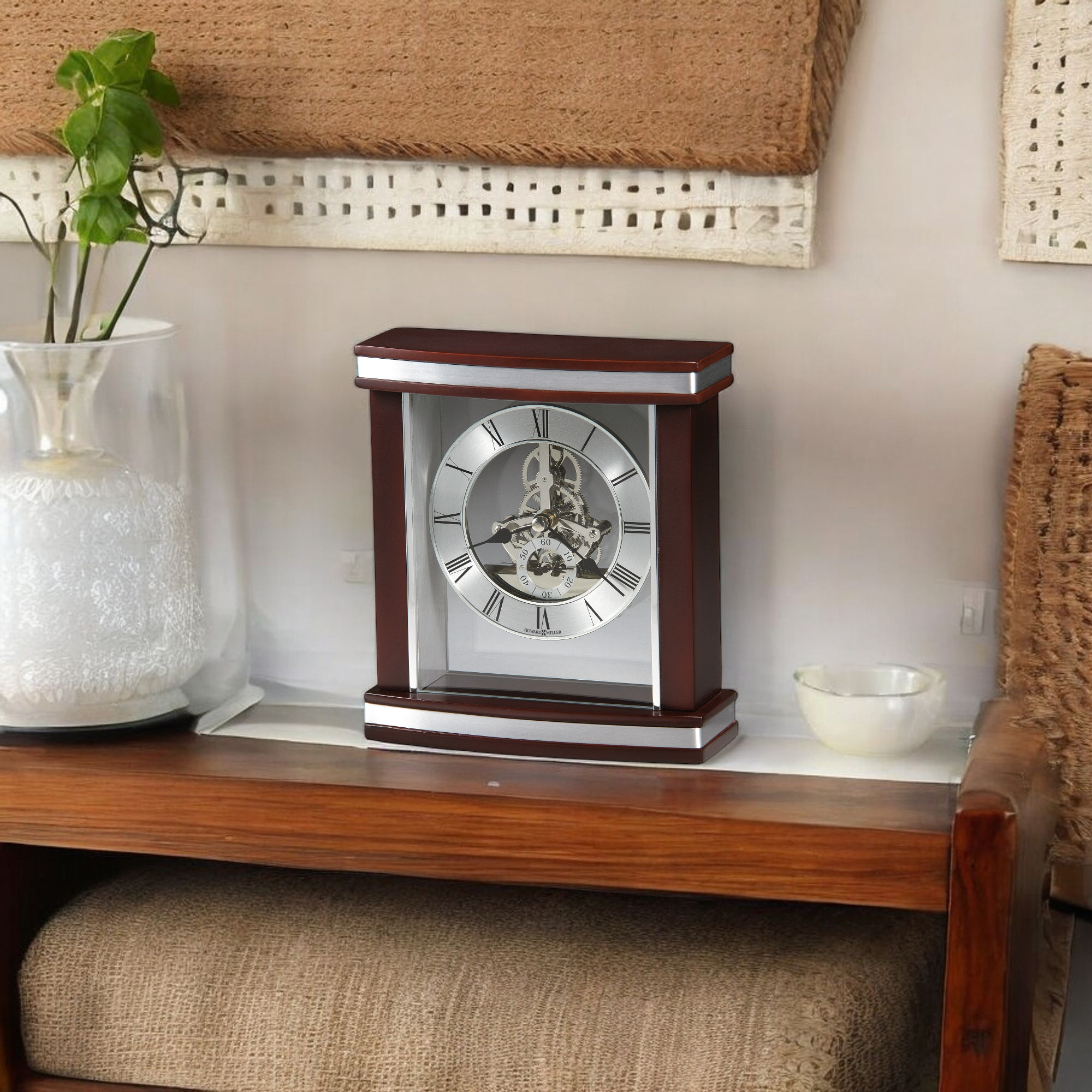 A decorative clock with a silver face and wooden frame placed on a coffee table.