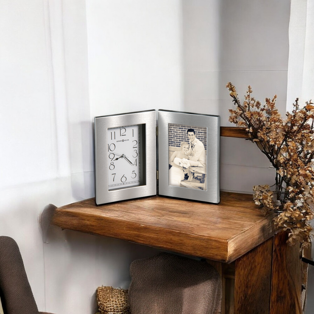 A decorative wooden table displaying a photo frame with an old photograph and a clock.