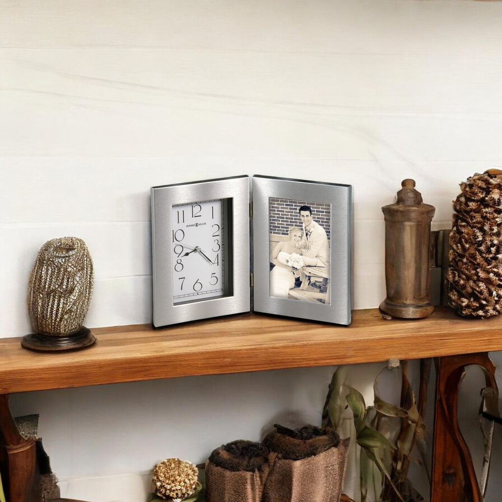 A decorative shelf displaying a clock and a photo frame with a vintage photograph.