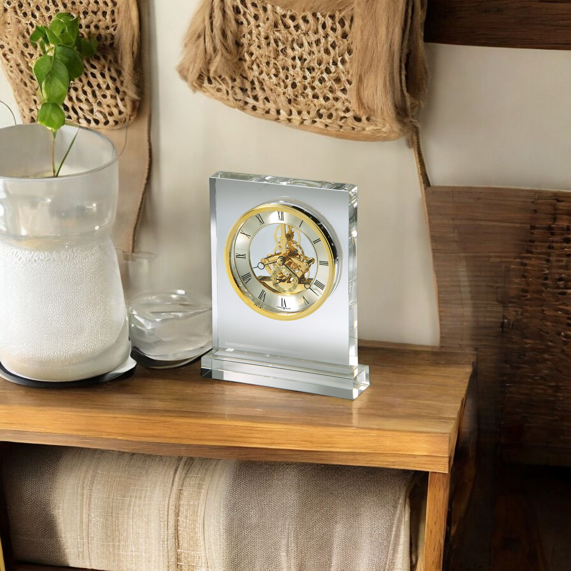 A crystal clock displayed on a wooden table in a cozy room setting.