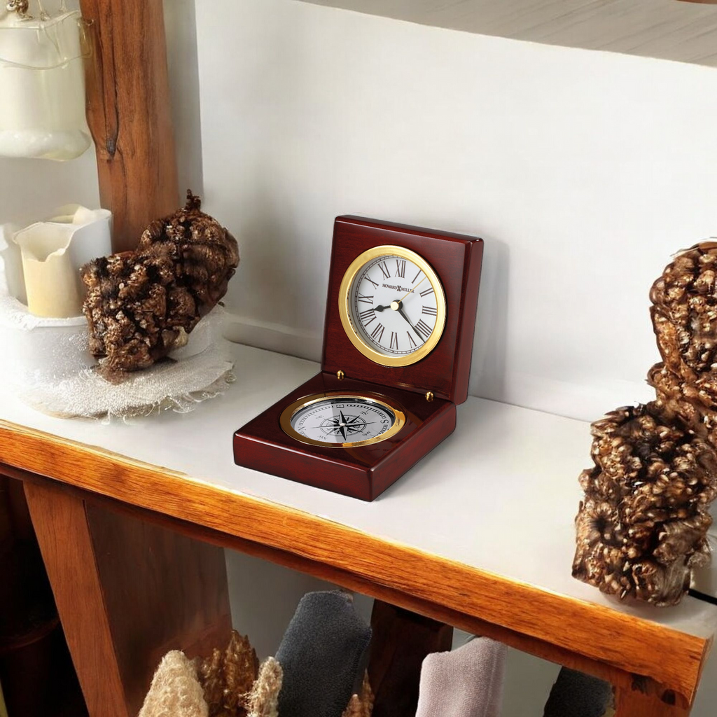 A wooden shelf displaying a decorative clock and compass, surrounded by natural decor.