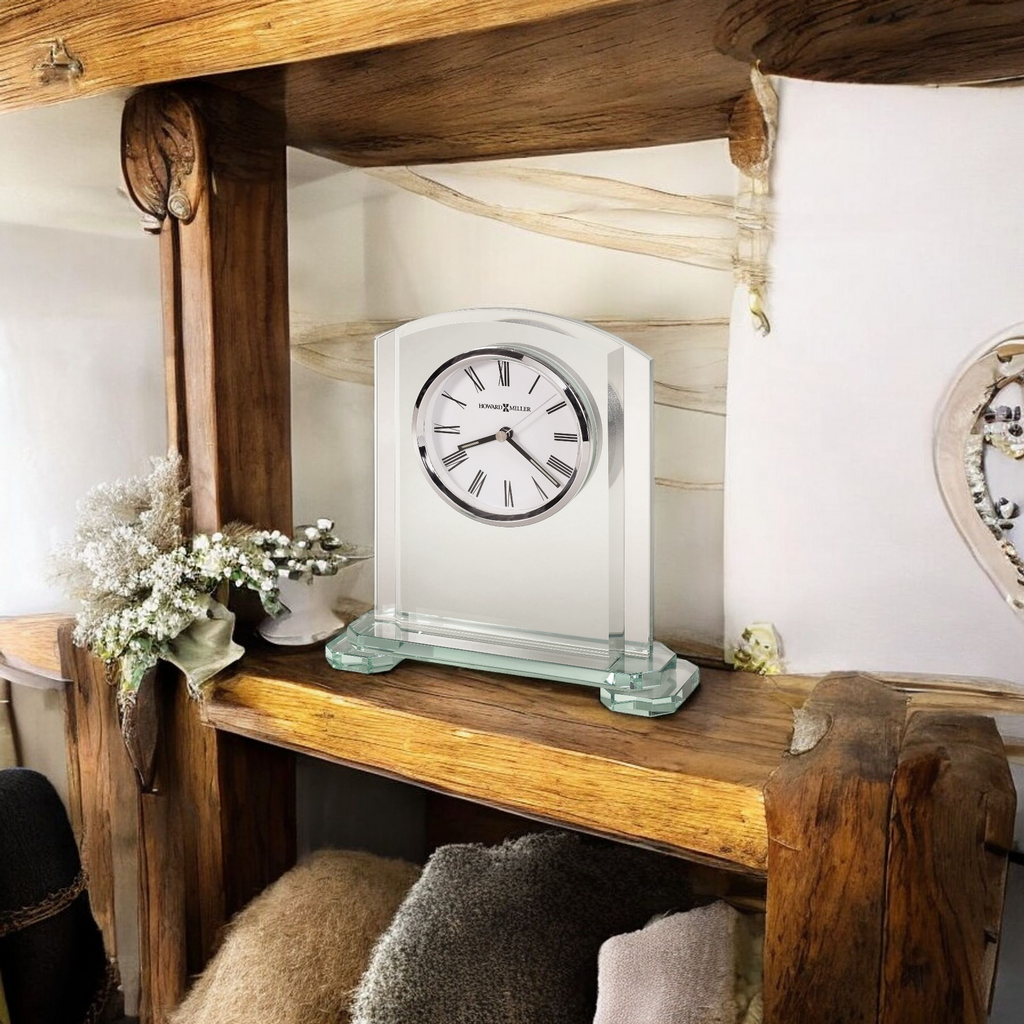 A decorative clock on a wooden shelf with various accessories.