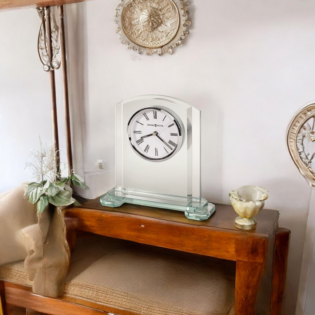 A decorative glass clock on a wooden table with a cozy interior setting.